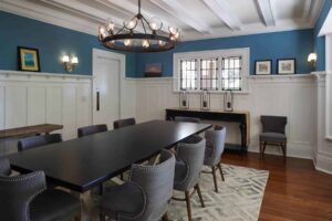 dining room with custom woodwork and wood floors.