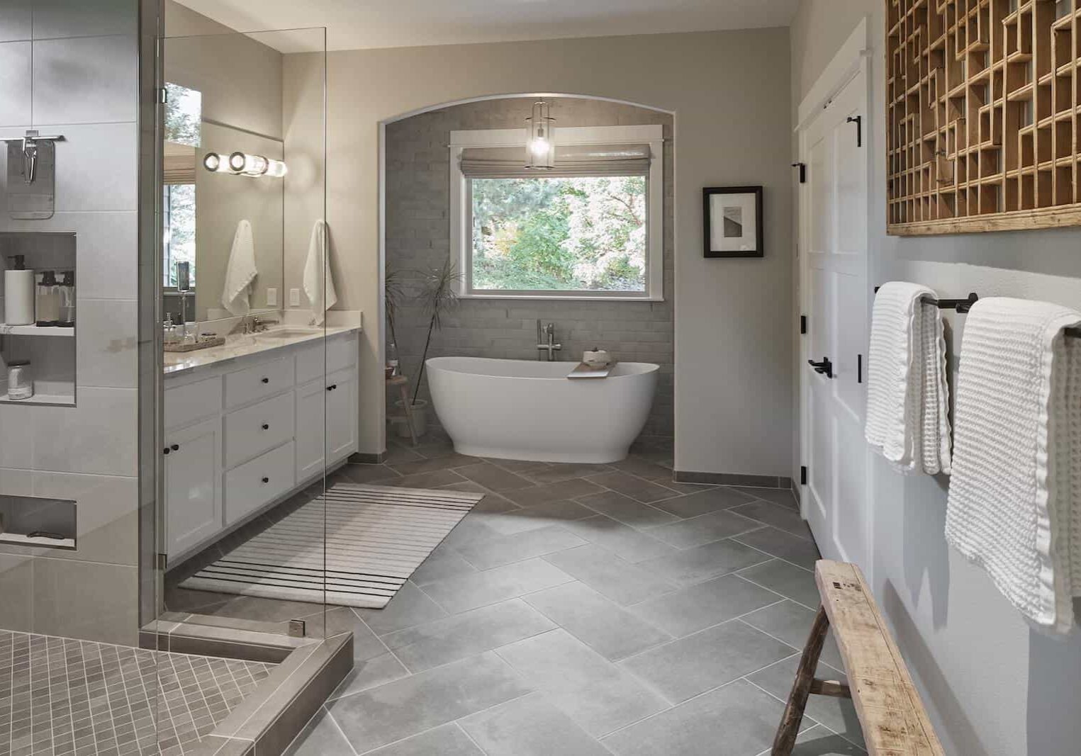 large bathroom with tile, tub and glass enclosed shower